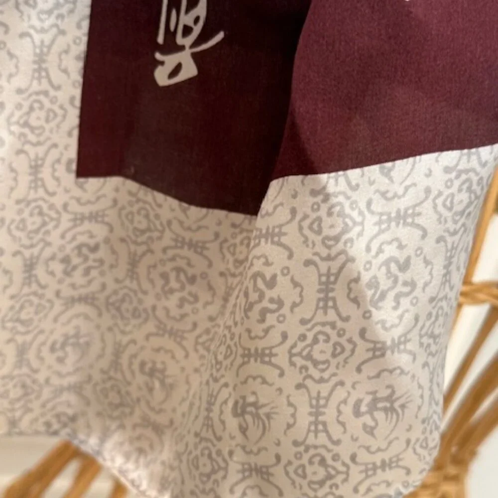 100% silk wine colored and silver oblong scarf.